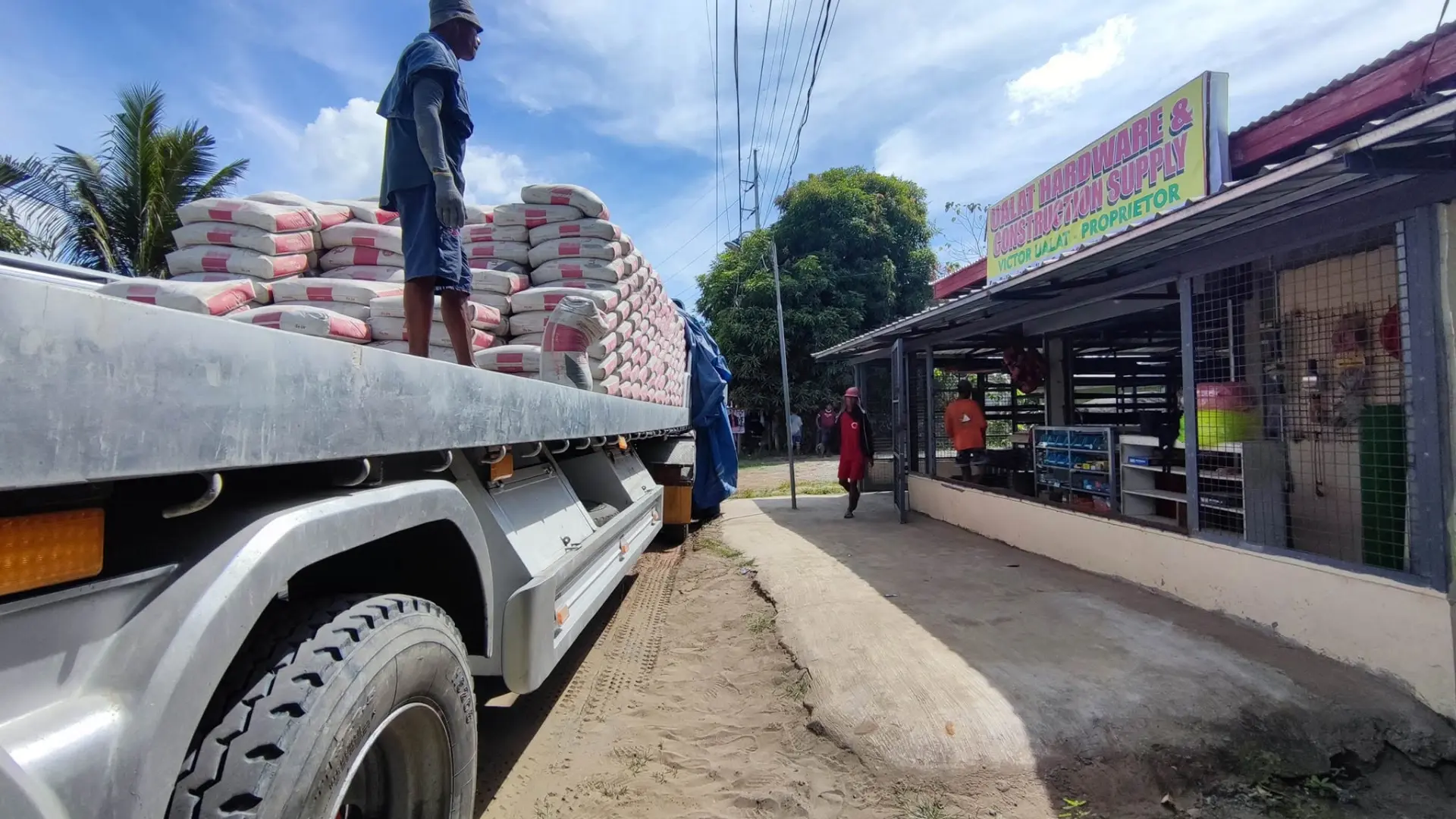 Cement bags being unloaded at Ualat Hardware and Construction Supplies in Echague, Isabela