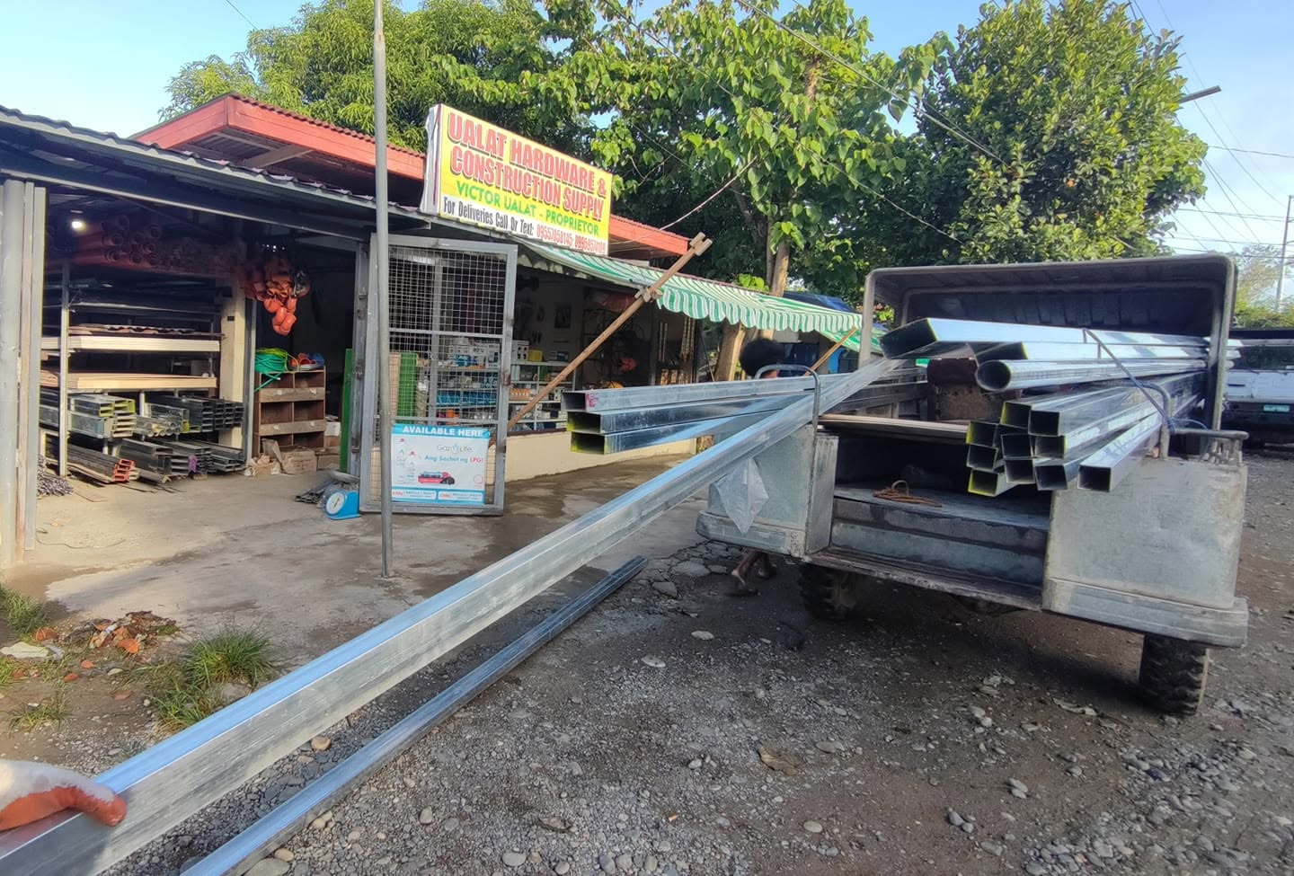 Ualat store frontage with steel being loaded